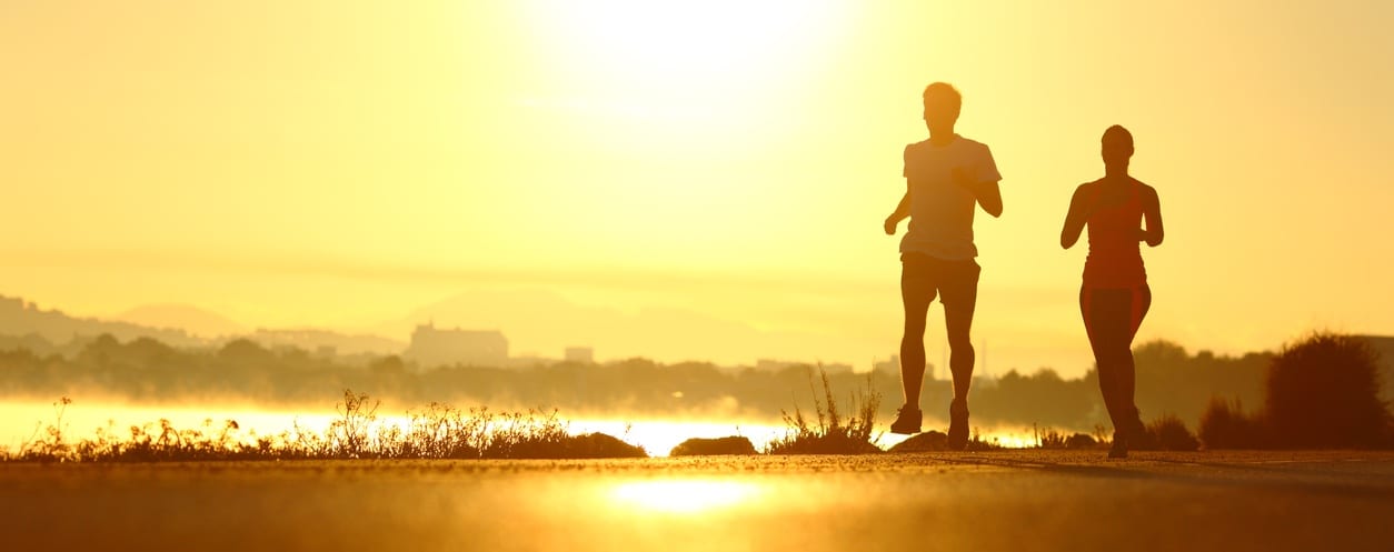 joggers at sunset