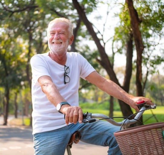 man smiling on bike, actinic keratosis treatment