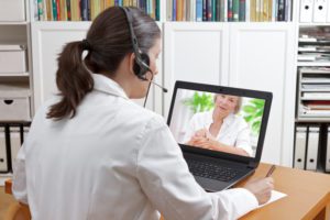 Doctor during an onlinecall with a female patient showing a large mole